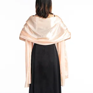 Rear view of a champagne satin shawl elegantly draped over a black evening dress