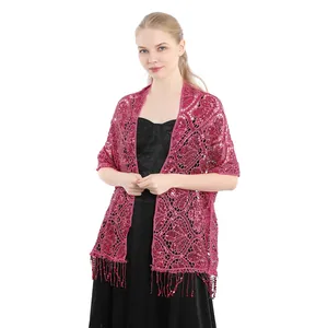Detail view of an elegant magenta sequin fringe shawl over a black evening dress
