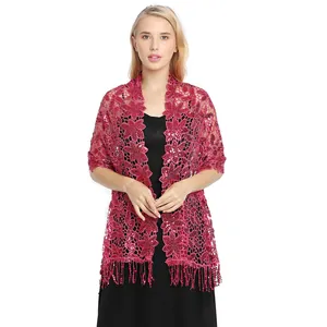 Detail view of magenta floral crochet shawl with sequins and tassels for evening wear