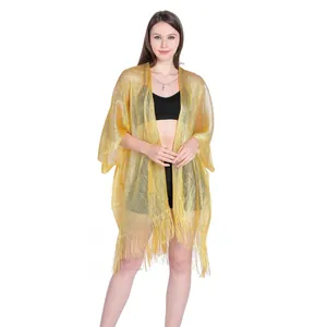 Close-up detail of the gold shimmery fabric and fringe hem on this beach cover-up cardigan