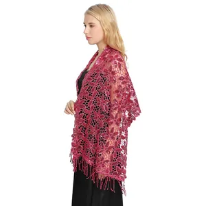 Detail view of a magenta sequin lace shawl with elegant fringe for evening gowns.