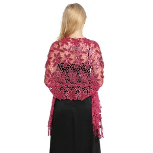 Detailed macro view of the intricate pink floral lace and sequins on the party shawl.