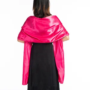 Detail of magenta satin shawl worn over a black dress for formal evening occasions.