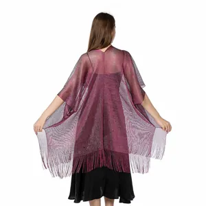 Back view of shimmering metallic evening shawl with fringe detail over black dress