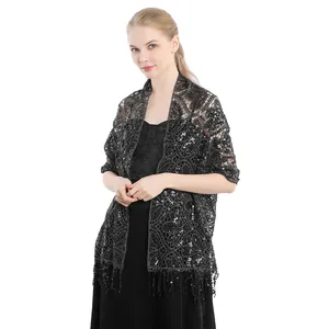 Detail of elegant black lace shawl featuring intricate sequin embroidery and fringe