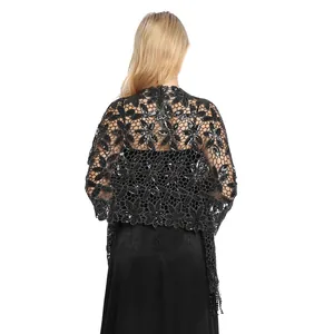 Detailed back view of a black sequined shawl with fringe and floral lace patterns.
