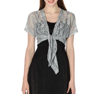 Detailed view of grey floral lace shrug with tie-up design over a black dress