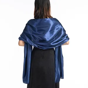 Back view of a glossy dark blue satin shawl draped elegantly over a black evening dress wrap