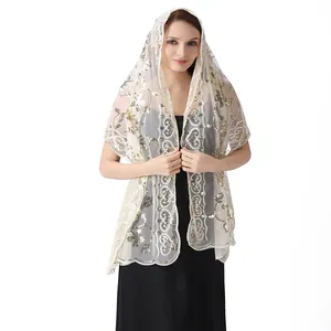 Detailed view of elegant sequined lace bridal shawl with gold embroidery on white lace