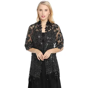 Detailed view of elegant black sequined lace shawl with fringe for evening party wear