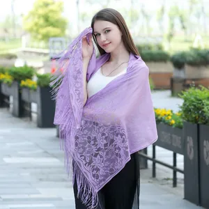 Detailed view of the purple floral lace pattern and delicate fringes of this shawl.