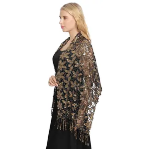 Close-up of the delicate gold sequin floral embroidery and hanging tassels on the mesh shawl