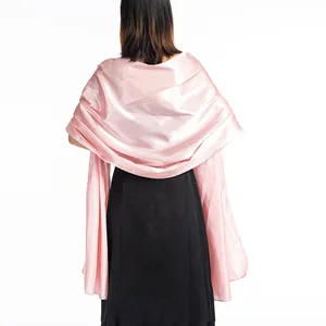 Elegant pink satin shawl detail showing smooth texture on back of evening dress