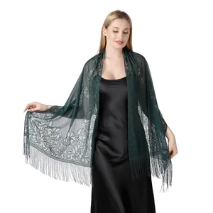 Detail view of a dark green hollow floral lace shawl with elegant long fringe tassels