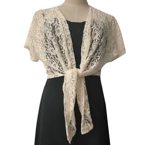 Detailed view of an ivory floral lace tie-front bolero shawl on a black dress.