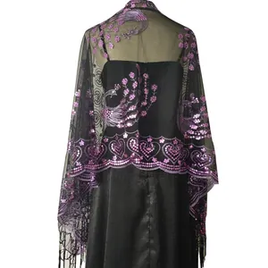 Close-up of black sheer shawl featuring purple sequin peacock embroidery and tassels