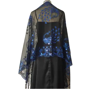 Detailed back view of black mesh shawl with royal blue sequin peacock embroidery