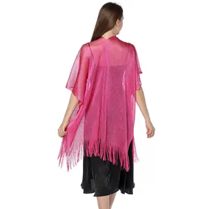 Detailed back view of a shiny pink metallic shawl with fringe worn over black dress