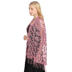 Detail view of pink floral lace shawl with sparkling sequins and elegant tassels.