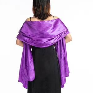 Detailed rear view of an elegant purple satin evening shawl paired with a black dress.