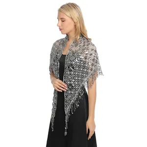 Elegant detail of silver mesh sequin tassel shawl paired with a black evening dress