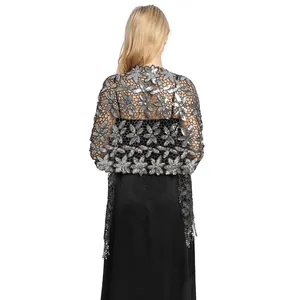Detail view of silver floral sequin shawl with elegant tassels for evening party wear