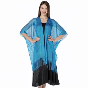 Detail view of the metallic blue mesh texture and delicate fringe hem of the shawl.