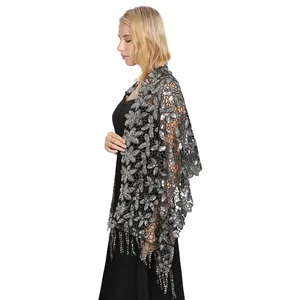 Elegant side view of a black evening shawl with silver sequins and floral lace texture