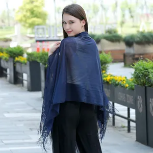 Back view of elegant navy blue lace shawl with fringe detailing for evening dresses