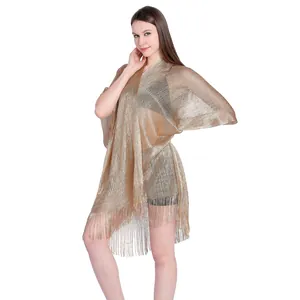 Shimmering gold metallic shawl featuring long fringe and elegant holiday beachwear design