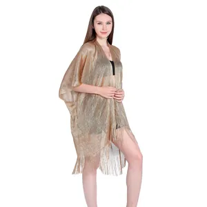 Metallic gold oversized beach cover-up with tassel hem detail for summer vacation wear