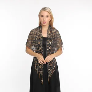 Elegant sequined evening wrap shawl with fringe tassels worn by a model in front view