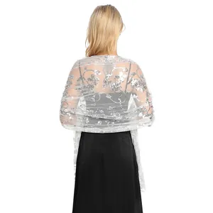 Rear view of white sequined lace shawl with floral pattern on elegant black dress.