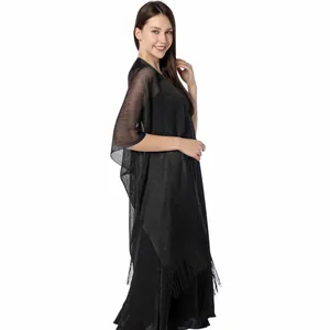 Detailed side view of black shimmering metallic shawl with elegant fringe for evening wear
