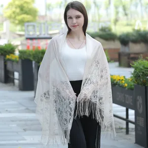 Elegant cream lace wedding shawl with beautiful floral patterns and fringe trim.