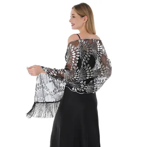 Detail view of black mesh shawl with silver sequin peacock pattern and elegant tassels