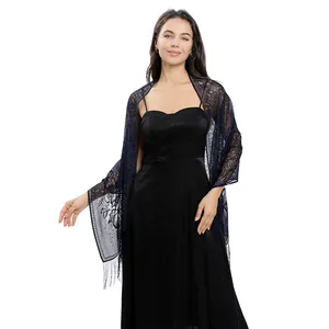 Detailed view of navy blue lace evening shawl with floral patterns and fringe on a model
