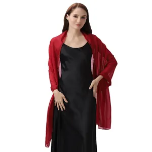Red metallic crinkle evening shawl worn over a black satin slip dress for party
