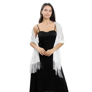 Elegant white lace shawl with long tassels paired with a black dress for parties.