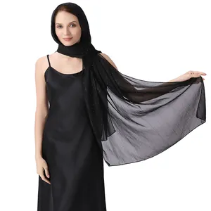 Elegant black chiffon shawl with silver wire and sparkling rhinestones on evening dress.