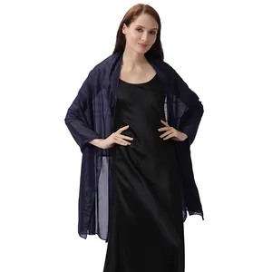 Close-up of elegant navy blue evening shawl scarf with metallic glitter texture