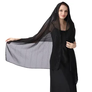 Elegant detail view of black chiffon shawl with silver thread and sparkling rhinestones