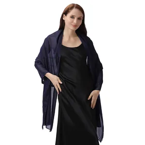 Elegant navy blue glitter shawl wrapped around a satin black evening gown on a model