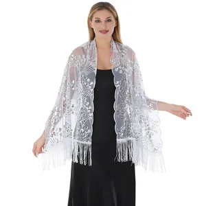 Elegant white sheer shawl with silver sequins and fringe details worn by a model