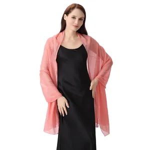 Medium shot showing a pink chiffon shawl with silver threads worn over a black dress