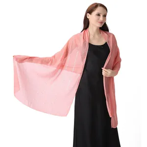 Detailed view of elegant coral chiffon shawl featuring silver silk threads and rhinestones