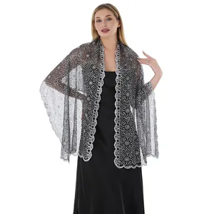 Detailed view of elegant silver sequined plum blossom embroidery on a bridal shawl
