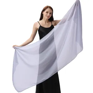 Model showcasing a light purple shimmering sheer evening shawl on a white background
