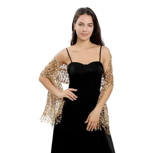 Detailed view of elegant gold sequin embroidered shawl with fringe detail on female model