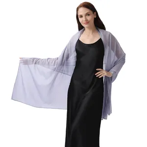 Detail showing the sheer texture of a lavender shiny crepe shawl on a black dress